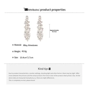 Detail view of large teardrop earrings with silver finish and sparkling crystal fringe