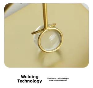 Macro detail of golden metal welding process with crystal ball for durable napkin holder