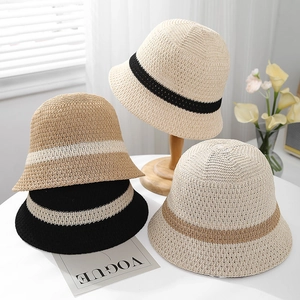 Detailed view of breathable woven straw bucket hats with contrasting color stripe patterns