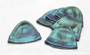 Close-up of metallic knit beanies featuring holographic color-changing texture