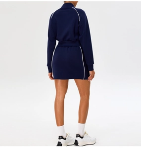Back view of navy blue sportswear set with white piping on collar and mini skirt