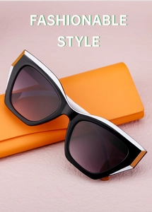 Cat eye sunglasses with black-white contrast frame and purple gradient lenses in orange case