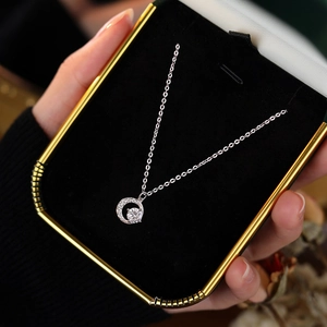 S999 sterling silver crescent moon necklace with shiny zircon stones in a jewelry box