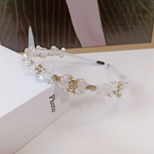 Detailed macro of crystal beads and gold flower ornaments on a handmade headband