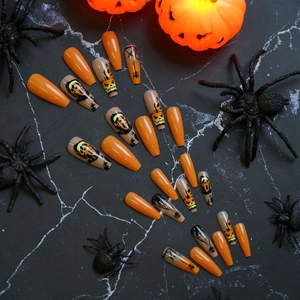 Long coffin Halloween press-on nails with orange pumpkin faces and spider web patterns