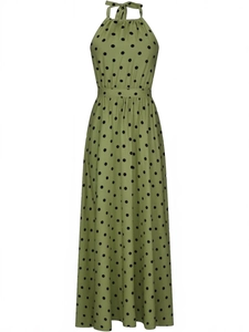 Green halter neck maxi dress with black polka dots and pleated hemline for summer