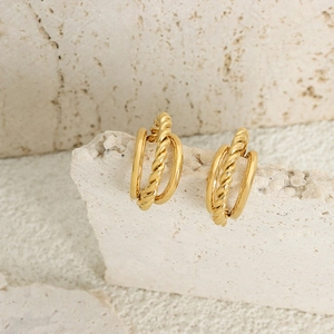 18K gold plated twisted rope C-shape hoop earrings in stainless steel on stone background