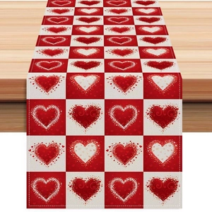 Close-up of red heart patterns on checkered linen table runner for Valentine decor