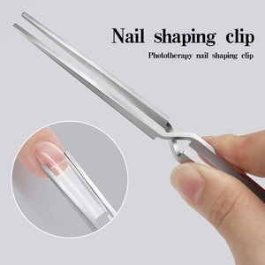 Macro detail of stainless steel X-type nail pinching tool used for shaping gel extensions