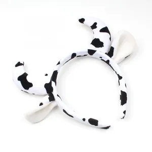 Detail of plush cow ear headband with black and white spots for costume dressing