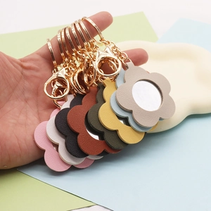 Detail view of flower-shaped leather keychains with mirrors in eight vibrant colors