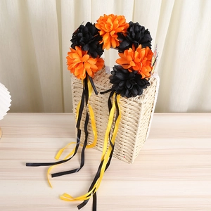 Detail of bohemian floral headband with orange and black flowers on a woven basket