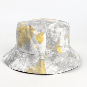 Detail of gray and yellow tie-dye patterns on thick twill cotton bucket hat texture