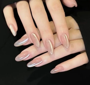 Close-up of almond-shaped cat-eye press-on nails in nude pink pearl finish