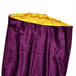 Detail view of purple satin fabric with elegant pleats and yellow elastic lining waist