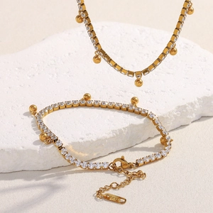 Detailed macro of 18K gold plated stainless steel bracelet with zircon beads and tassels