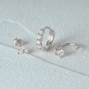Macro detail of 3-piece S925 silver earring set with sparkling white zircon stones