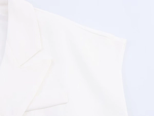 Detail shot of white linen blend vest showing premium twill fabric texture and lapel sewing