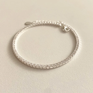 Close-up of minimalist S925 sterling silver tennis bracelet with cubic zirconia and lobster clasp