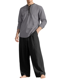 Detail of grey Henley neck linen shirt and black wide-leg trousers showing fabric texture