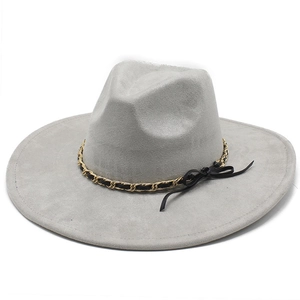 Detail of light gray suede fedora featuring a gold chain and black leather bow band decoration
