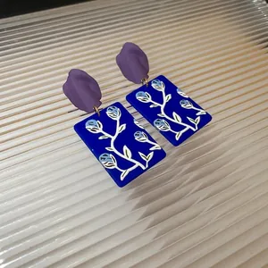 Artistic blue and purple painted flower earrings with vintage floral resin patterns