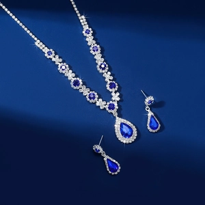 Luxury blue teardrop crystal necklace and earring set with silver pave diamond accents
