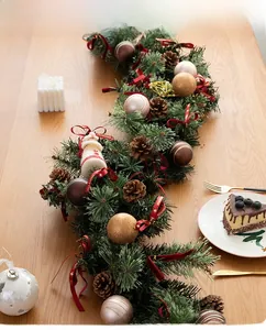 Close-up of 135cm Christmas garland with pine cones, golden ornaments and velvet bows