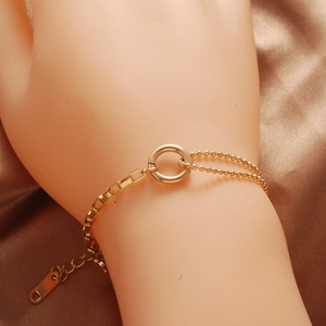 Gold asymmetrical titanium steel bracelet with rectangle links, bead chains and central ring