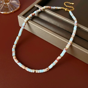 Close-up of Shoushan stone beaded necklace with light blue and patterned cylindrical beads