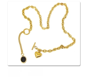 Detail of 18k gold plated heart necklace with black oval gemstone and OT buckle clasp