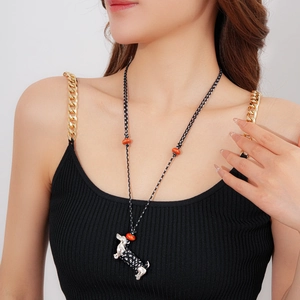 Detail of woven rope necklace featuring a silver dachshund pendant with black polka dots