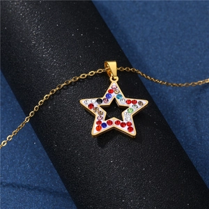 Golden star pendant necklace with colorful crystals on a textured blue background