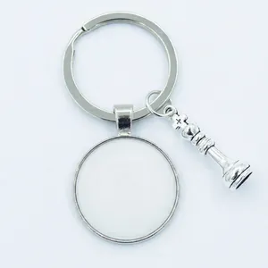 Silver metal keychain with chess piece charm and custom photo pendant on white background
