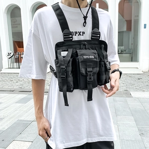 Detailed view of black tactical chest rig with multi-pockets and adjustable nylon straps
