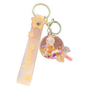 Pink glitter liquid bear keychain with a lollipop-shaped capsule and a silicone wrist strap
