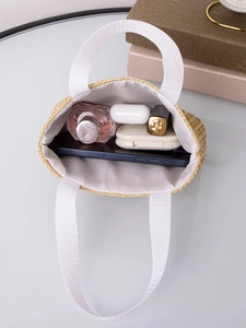 Top view of woven tote showing large capacity with phone, perfume, and daily essentials