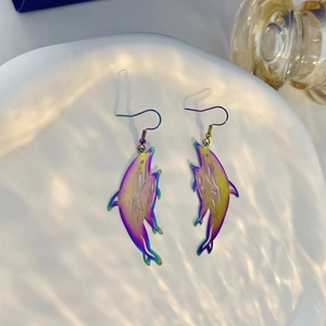 Macro detail of iridescent laser dolphin earrings with hollow design and aquatic lighting