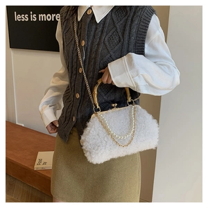 Detail of white lamb wool bag with bamboo handle, pearl chain and vintage metal clasp