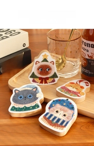 Detail view of four cartoon cat wooden bottle openers with magnet on a tray