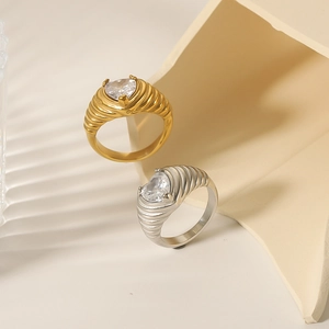 Two heart-shaped zircon rings in gold and silver with thick twisted band design