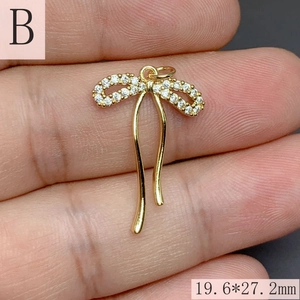 Macro detail of micro-pave zircon bow pendant with 19.6mm by 27.2mm dimensions