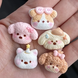 Five cute resin cartoon dog head accessories held in hand for size reference