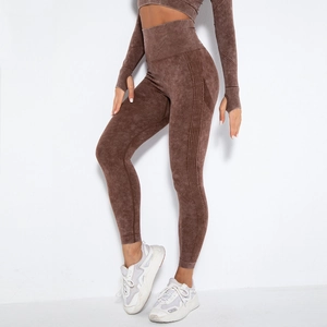 Detail of high-waisted seamless yoga leggings and long sleeve crop top in coffee brown wash