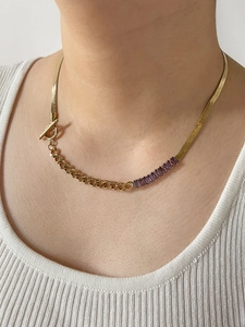 Detail of gold snake chain with purple rectangle zircon and OT toggle clasp closure