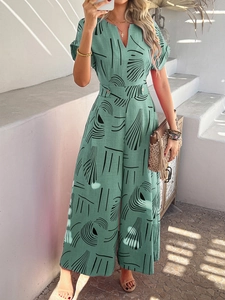 Floral print wide-leg jumpsuit with V-neck and button waist detail for beach vacation