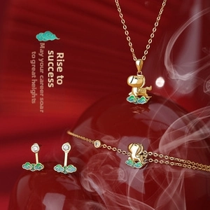Detailed macro view of S925 silver jewelry set featuring green enamel and gold finish