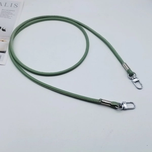 Detail of grass green PU leather strap with white stitching and silver metal lobster clasps