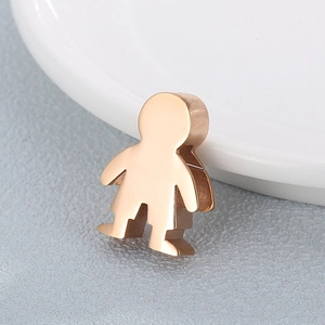 Polished gold stainless steel cartoon human figure pendant shown in a macro perspective