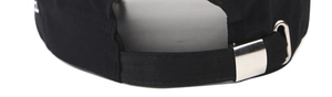 Detail of black baseball cap featuring silver metal buckle and white logo embroidery